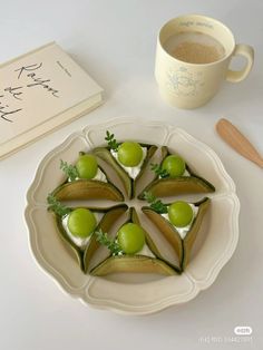 a plate that has some food on it next to a book and cup with spoons