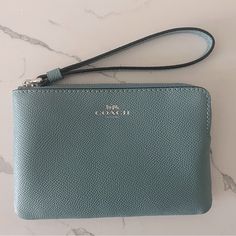 Nwot Coach Wristlet Coach Corner Zip Wristlet Color: Light Teal / Silver Model: 58032 Crossgrain Leather Silver Logo Two Credit Card Slots Zip-Top Closure, Fabric Lining Wrist Strap Attached 6 1/4" (L) 4" (H) 1/2" (W) Coach Blue Wristlet For Travel, Coach Wristlet With Wrist Strap For Travel, Blue Wristlet With Zipper Pouch For Daily Use, Blue Wristlet With Zipper Pouch For Travel, Everyday Blue Pouch Wristlet, Coach Blue Clutch For Everyday Use, Blue Coach Clutch For Everyday Use, Blue Travel Wristlet With Removable Pouch, Coach Wristlet With Wrist Strap For Daily Use