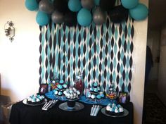 a party table with balloons and desserts on it