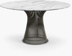 an oval marble dining table with black metal base and round white marble top, viewed from the front