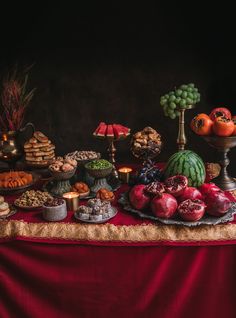 a table topped with lots of different types of foods and desserts on top of it