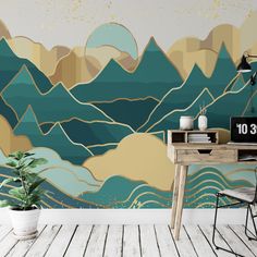 a desk and chair in front of a wall mural with mountains on the back ground