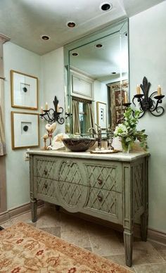 a bathroom sink sitting under a large mirror