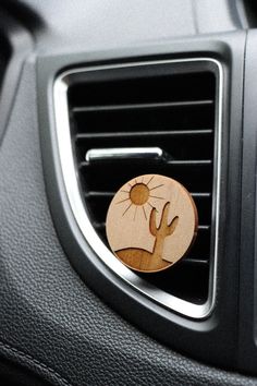 a car air vent with a wooden sticker on it