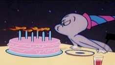 a cartoon character blowing out candles on a cake