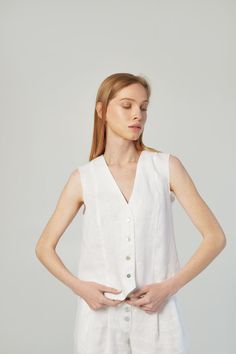 A perfect linen vest top could be a formal outfit and also free style. It depends on your own style, accessories, and occasion. This classic top suit for ladies who appreciates sophistication and minimalism. Made of natural linen of the highest quality and flawlessly cut, this thing is suitable for the wardrobe in trendy "old money" and "coastal grandmother" styles. Free cut, with folds 4 buttons made from seashells Length 50cm/20inches Raw armhole effect with backstitching Linen belt with raw edges included Color of the belt: sky blue Belt loops on the right side Sizes: XS, S, M, L, XL, XXL Custom sizes are available Made of 100% natural linen, Oeko-Tex certified, free of harmful chemicals. It keeps the temperature of the body + -4 degrees, these clothes are not hot in summer and not cold White Linen Sleeveless Vest, Fitted Linen Tank Top For Everyday, Chic Fitted Linen Tank Top, White Linen Vest For Workwear, Elegant White Vest Top, White Linen Casual Vest, White Summer Workwear Vest, Elegant Linen Tank Top For Work, Classic White Tank Top For Spring