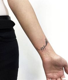 a woman's arm with a small tattoo on the left side of her wrist