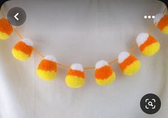 an orange and white pom - pom garland is shown