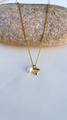 Gold Pearl Heart Necklace - Mini Pearl Necklace - Heart Pendant Necklace  *WATERPROOF *You can wear gym, pool, shower or everywhere *Tarnish Free *Hypoallergenic *The necklace are hand crafted METARIAL  Pearl Material : Fresh Water Pearl - 7 mm Gold Mini Heart 10x10x4mm    Dainty Chain Gold plated over stainless still FREE SHIPPING Pearl And Heart Necklace, Heart Pearl Necklace, Ocean Necklace, Gold Locket, Gold Pearl Necklace, Gold Heart Necklace, Etsy Bridesmaid Gifts, Mini Heart, Anniversary Gift For Her