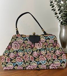 1960s Floral Tapestry Top Handle Convertible Handbag, 60s Vintage Purse, Vintage Accessory  Two in one handbag from the 1960s. The outer cover of the handbag is a floral tapestry that easily snaps off for a sleek black handbag. It has a single black vinyl handle strap. Gold tone metal frame with a thumb lift closure that works well and closes tightly. Opens to a black vinyl lining. Nearest mint condition *the exterior is immaculate.  The lining is immaculate with no stains or holes.  The metal h Vintage Rectangular Bags For Vintage Events, Vintage Rectangular Bags For Events, Vintage Rectangular Evening Bag, Vintage Evening Bag With Detachable Strap And Top Handle, Vintage Satchel With Detachable Strap And Tote Shape, Vintage Multicolor Satchel With Removable Pouch, Vintage Multicolor Satchel With Handles, Vintage Multicolor Shoulder Bag With Top Carry Handle, Vintage Multicolor Bag With Detachable Strap