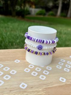 Enjoy this 3 bracelet set hand-crafted with clay and enamel beads in a purple theme. Bracelets are elastic banded and stretch to fit an average size female wrist. Celebrate any day with this fun jewelry that includes smiley face and purple. Bracelet Sets Diy, Fun Purple Bracelets For Friendship, Playful Purple Friendship Bracelets With Round Beads, Cute Adjustable Purple Friendship Bracelets, Cute Purple Friendship Bracelets With Letter Beads, Playful Purple Beaded Bracelets As A Gift, Playful Purple Beaded Bracelets For Gifts, Playful Purple Beaded Bracelets As Gift, Cute Purple Bracelets With Colorful Beads