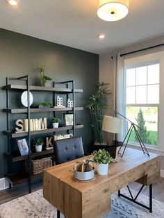 a living room filled with furniture and a wooden table in front of a large window