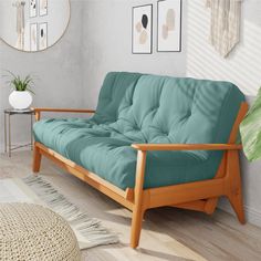 a living room scene with focus on the futon and rug in the foreground