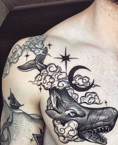 a man with tattoos on his chest has a shark and moon tattoo on it's chest