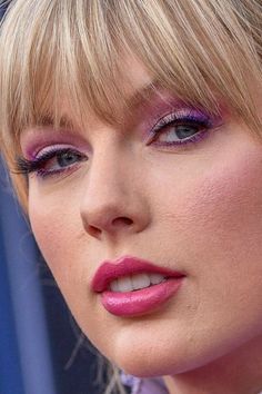 a close up of a person wearing purple lipstick