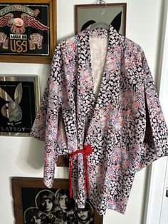 Vintage 1960's Cherry Blossom Floral Japanese Custom Made Printed Pink Silk Kimono * Black Purple Pink and Blue * Red Cerimonial Tie * Size Medium Gorgeous and unique vintage silk pink kimono with all over floral print.  This was custom made, no fabric or tag labels. Super lightweight fabric with a nice weight and beautiful silky feel. Red rope tie closure, classic square kimono sleeve with inside tie to secure closed. Fits like a size medium.   Measurements :  Sleeve length : 13.5 in Length : 3 Red Vintage Kimono For Spring, Vintage Floral Print Festival Kimono, Vintage Floral Print Kimono For Festival, Vintage Black Kimono For Spring, Vintage Multicolor Spring Kimono, Vintage Multicolor Kimono, Red Vintage Cotton Kimono, Vintage Red Cotton Kimono, Vintage Cotton Kimono For Spring