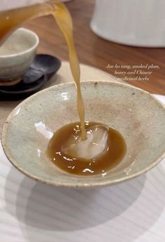 a bowl filled with liquid sitting on top of a table