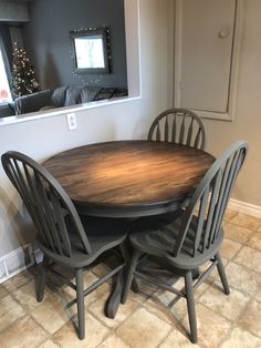 a dining room table with four chairs around it