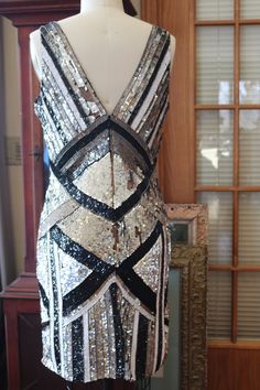 Black white silver striking beaded pattern on this fabulous flapper dress! This is a stunner! More pics: https://www.facebook.com/pg/RetroVintageWeddings1920s1930s/photos/?tab=album&album_id=2682689598493733 Art Deco Fitted Sequined Flapper Dress, Fitted Art Deco Flapper Dress Embellished, Fitted Art Deco Embellished Flapper Dress, Fitted Embellished Flapper Dress In Art Deco Style, Fitted Flapper Dress With Sequins For Party Season, Gatsby Style Fitted Sequin Dress For Party Season, Fitted Sequin Flapper Dress For Party Season, Gatsby Style Fitted Sequin Cocktail Dress, Fitted Gatsby Sequin Cocktail Dress