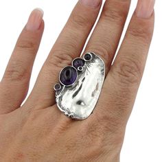 Beautiful NEW handcrafted Sterling silver Ring with five genuine natural Amethyst stones (one oval 12mmX8mm and four round 6mm, 4mm, 3mm, 2mm) all inlaid in polished curved solid silver. Must see Size: can be resized at your request. Stones: genuine natural Amethyst Sterling silver (925) Front width: 39mm / 1.535 in. Back width: 8mm / 0.314 in. Stamped 925. This beauty will be sent to you in a gift package. (All stains, if are any, are due to camera). Please feel welcome to contact me if you hav Purple Stone Ring, Purple Stone Rings, Big Rings, Ring Vintage, Amethyst Ring, Stone Ring, Gemstone Ring, Handmade Silver, Jewelry Inspiration