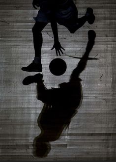 the shadow of a person playing with a soccer ball