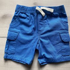 Kids Headquarters Bright Blue Cargo Style Drawstring Shorts. Pull on elastic waist with drawstring. Size 12 months. New without tag attached Cheap Blue Cargo Shorts For Summer, Cargo Style, Drawstring Shorts, New Kids, Bright Blue, Cargo Shorts, 12 Months, Mens Short, Elastic Waist