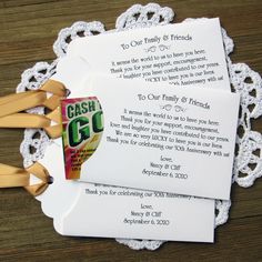 two cards with clothes pins attached to them on top of a doily that says cash go