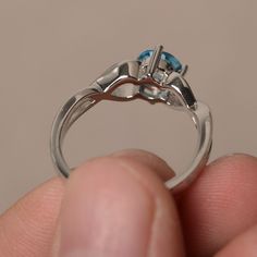 This is a gorgeous handmade creation. Its beauty is its simplicity & Elegance. The 6*6 mm round shape faceted real Swiss Blue Topaz is crafted in solid sterling silver and with rhodium plated. All item is sent in a beautiful gift box If you have any idea of design your ring,pls contact me directly. You can realize more lovely stuff clicking the link https://www.etsy.com/shop/knightjewelry?refshopsection_shophome_leftnav Please leave the correct address and you phone number for delivering suc Sterling Silver Round Topaz Promise Ring, Sterling Silver Solitaire Topaz Promise Ring, Topaz Birthstone Ring For Promise With Round Cut, White Gold Blue Topaz Birthstone Ring For Promise, Elegant Topaz Birthstone Ring For Promise, Round Aquamarine Birthstone Ring, Promise Topaz Birthstone Ring, Sterling Silver Topaz Gemstone Ring, Silver Topaz Ring With Round Blue Topaz