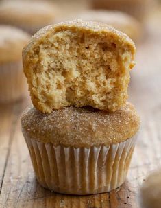 a muffin with a bite taken out of it on top of a wooden table