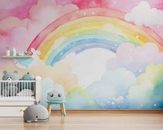 a child's room with a rainbow wall mural