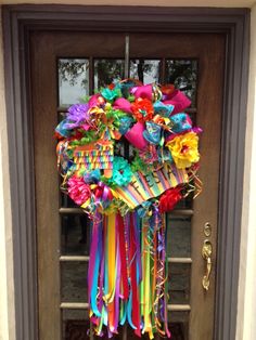 a bunch of colorful streamers hanging from the front door of a house on instagram