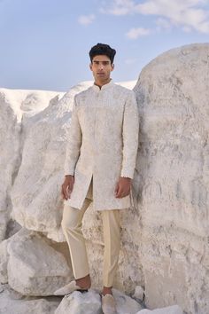 This off-white sherwani set features all over three-dimensional floral embroidery. The outfit is paired with a beige cotton silk kurta and matching cotton silk trouser.From Seema Gujral's Elements collection. DELIVERY TIMEPlease allow 6-8 weeks for your outfit to arrive. FABRIC DETAILSSherwani - Raw Silk Kurta - Cotton Silk Trouser - Cotton Silk Professional cleaning only. Open Sherwani, White Sherwani, Raw Silk Kurta, Beige Kurta, Seema Gujral, Kurta Cotton, Sherwani For Men, Kurta Men, Silk Kurta