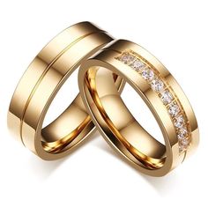 two gold wedding rings with diamonds on each one and the other in their center, against a white background