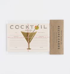 the cocktail recipe card is next to an envelope