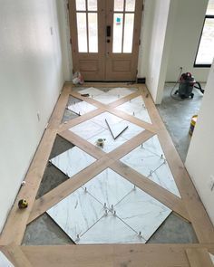 the floor is being laid out in front of the door to be installed on the side of the house