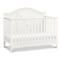 a white crib with no sheets on it