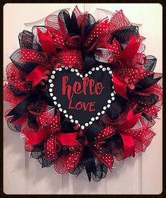 a red and black wreath that says hello love