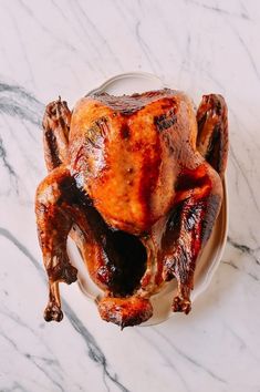 a roasted turkey on a plate with gravy