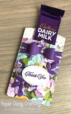 a bar of dairy milk with purple flowers on it