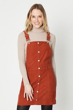 Button-through front bib with metallic buttons   Front bib pocket and two back patch pockets   Adjustable shoulder straps with buckle fastening   A-line silhouette in textured corduroy fabric  This cord dungaree mini dress from Oasis offers feminine flair with its soft pastel hue and flattering A-line silhouette. Crafted from textured corduroy fabric, it features a front bib with a pocket and metallic button closure that adds interest. Adjustable shoulder straps allow a customisable fit, while two back patch pockets provide functional detail. Style this versatile dress for day or night occasions. Its short length pairs perfectly with opaque tights and ankle boots for daytime wear. For evenings out, match with strappy heels and a leather jacket. The soft corduroy texture layers beautiful Christmas Party Shoes, Texture Layers, Corduroy Dungarees, Oasis Dress, Velvet Clothes, Sequin Outfit, Christmas Party Outfits, Oasis Fashion, Opaque Tights