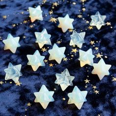 small white stars on a blue background with gold flakes and sparkles around them