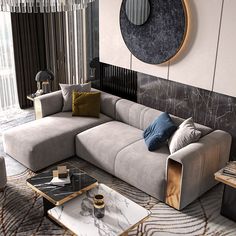 a modern living room with grey couches and marble coffee table in front of a round mirror