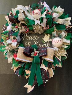 a wreath with peace on earth written on it