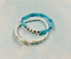 Set of two ocean inspired bracelets, made with stretchy string, friendship bracelet style Ocean-inspired Beaded Bracelets With Round Beads, Ocean-inspired Beaded Round Bead Bracelets, Ocean-inspired Beaded Round Bracelets, Adjustable Ocean Color Beaded Bracelets For Gifts, Adjustable Ocean-colored Beaded Bracelets For Gifts, Adjustable Beaded Bracelets In Ocean Color For Gift, Handmade Adjustable Ocean Color Bracelets, Adjustable Ocean-inspired Bracelet, Handmade Adjustable Blue Bracelets