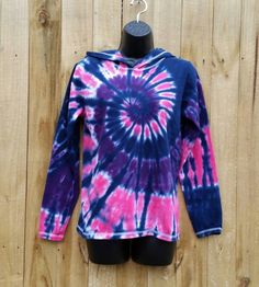 Every women's long sleeve hoodie was hand dyed with permanent fiber reactive dyes. On a new 100 % cotton adult unisex long sleeve tshirt hoodie in a size of your choosing A great layering piece that is super soft and comfy. Dyed in a vibrant mix of pink, purple and navy! Put some color into your wardrobe, buy tie dye :-) Available Sizes S ( 30-32) M (34-36) L (38-40) XL (42-44) 2XL (46-48) *As always all tie dyes are hand dyed with permanent fiber reactive dyes. So they will stay bright and vibr Acid Wash Cotton Hooded Top, Tie-dye Hooded Top With Drawstring, Tie-dye Hoodie With Drawstring Hood, Acid Wash Long Sleeve Hoodie, Winter Tie Dye Hoodie Top, Hand Dyed Long Sleeve Sweatshirt For Winter, Tie Dye Cotton Top With Drawstring Hood, Tie Dye Hooded Cotton Top, Hooded Tie Dye Cotton Top