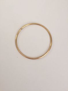 Let's get down to Brass...Stacks! Stack them high or wear one on its own, these bangles are sure to bring a touch of style to even the most casual of looks. Fabricated in jeweler's brass, these bangles are a great match (or substitute for) 14K yellow gold! These bangles are made in sturdy 10 gauge jeweler's brass wire and are measured by their interior diameters. Size Small - 2.25 inches (5.6cm). Size Medium - 2.5 inches (6.4 cm). Size Large - 2.75 inches (7 cm). If you are looking for a differe Brass Bangle Bracelet For Everyday Wear, Minimalist Brass Bangle, Everyday Metal Bangle, Vintage Brass Bracelet For Everyday Wear, Vintage Brass Bracelets For Everyday, Vintage Brass Bracelet For Everyday, Yellow Gold Hoop Bracelets, Everyday Vintage Brass Bracelet, Gold Hoop Bangle In Metal