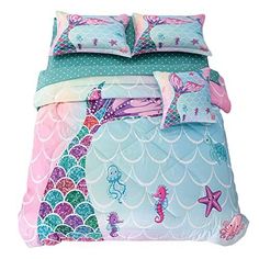 a bed with mermaid themed sheets and pillows