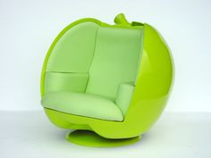 the green chair is shaped like an apple