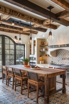 a kitchen with an island table and chairs in the center, surrounded by open windows