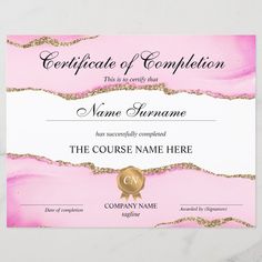 certificate of completion with pink marble and gold foil on the edges, in front of a white background